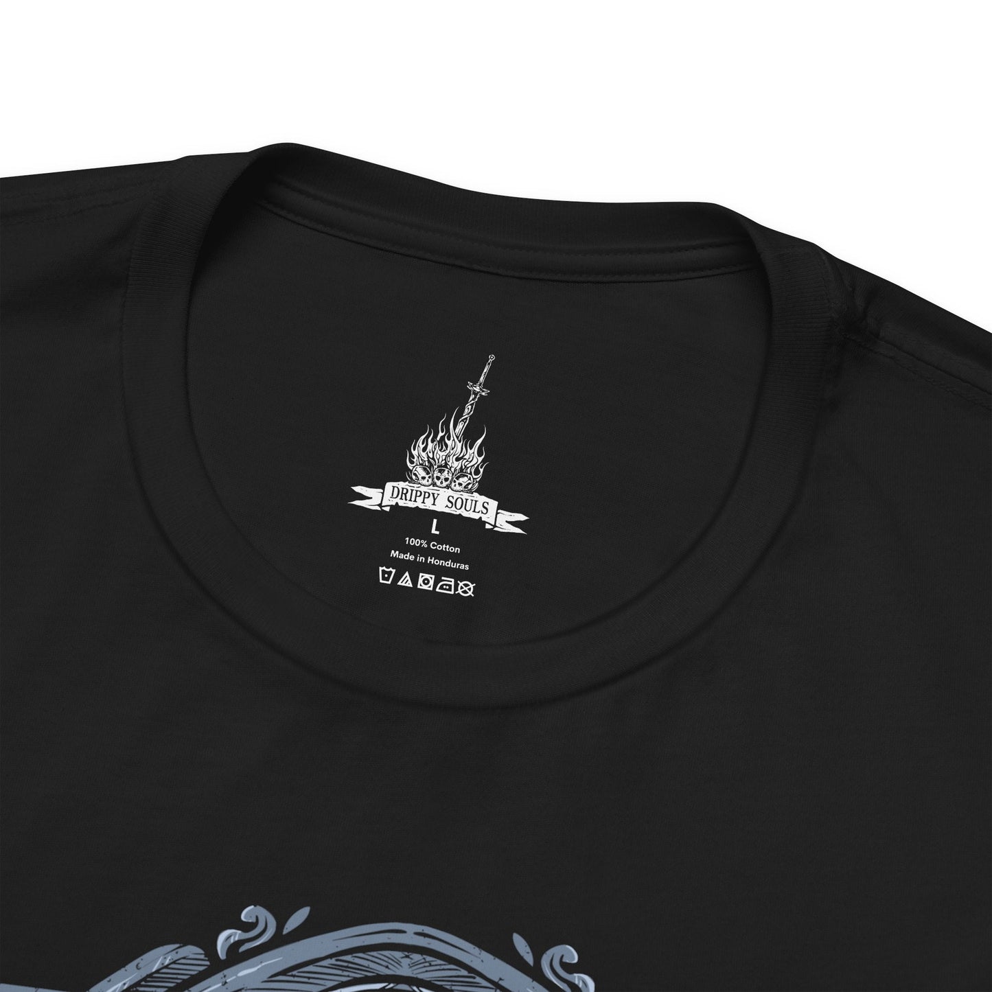 Folded T-Shirt design of the Dancer of the Boreal Valley from Dark Souls III, gliding through a shadowed cathedral with unnatural grace as blue and orange flames trail from her twin blades. Her elongated, spectral form twists mid-motion while darkness pools beneath her feet. The design captures eerie elegance, silent terror, and the haunting presence of a knight transformed into something inhuman.