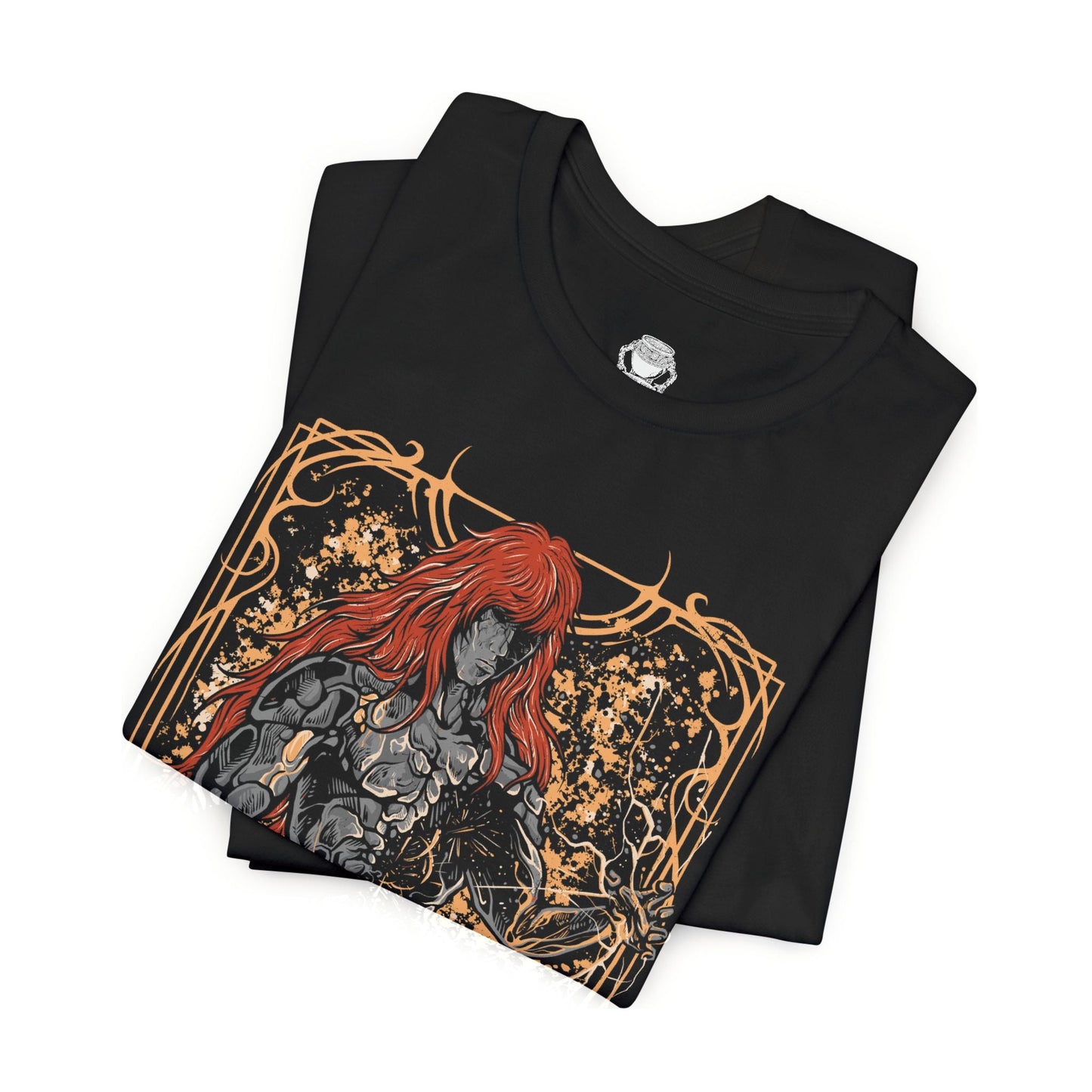 Folded T-shirt featuring Radagon of the Golden Order from Elden Ring, the divine champion and second Elden Lord. Both consort and counterpart to Queen Marika, Radagon embodies the perfection and tragedy of the Golden Order. This design captures his radiant red hair, golden rune magic, and divine form—symbolizing faith, conflict, and the duality of godhood and guilt.
