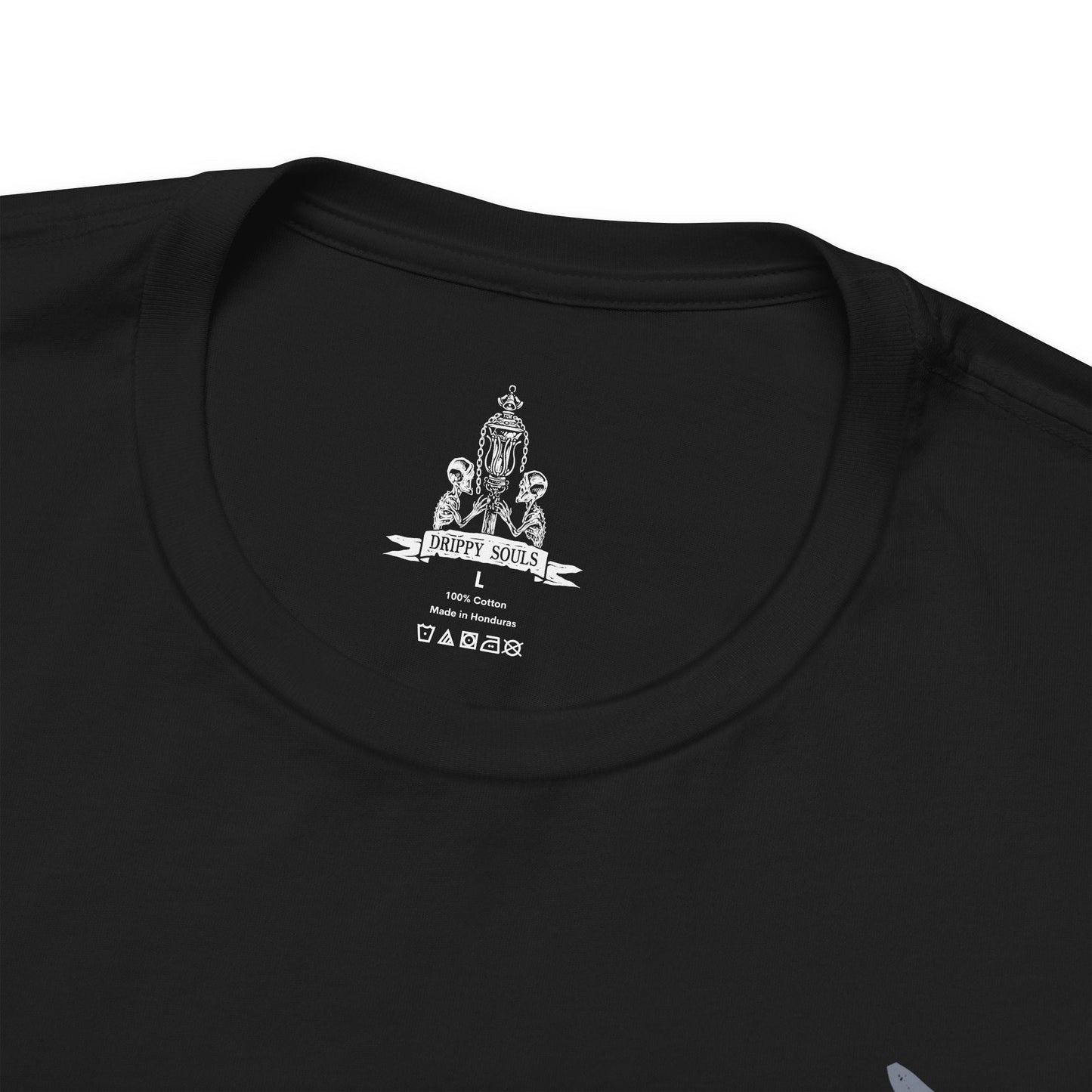 Folded T-shirt featuring Father Gascoigne from Bloodborne, the fallen hunter-priest defined by his relentless fighting style and tragic slide into beastly madness. Draped in worn cleric robes and armed with his signature hunter’s axe and blunderbuss, he embodies the fragile boundary between humanity and monstrosity.
