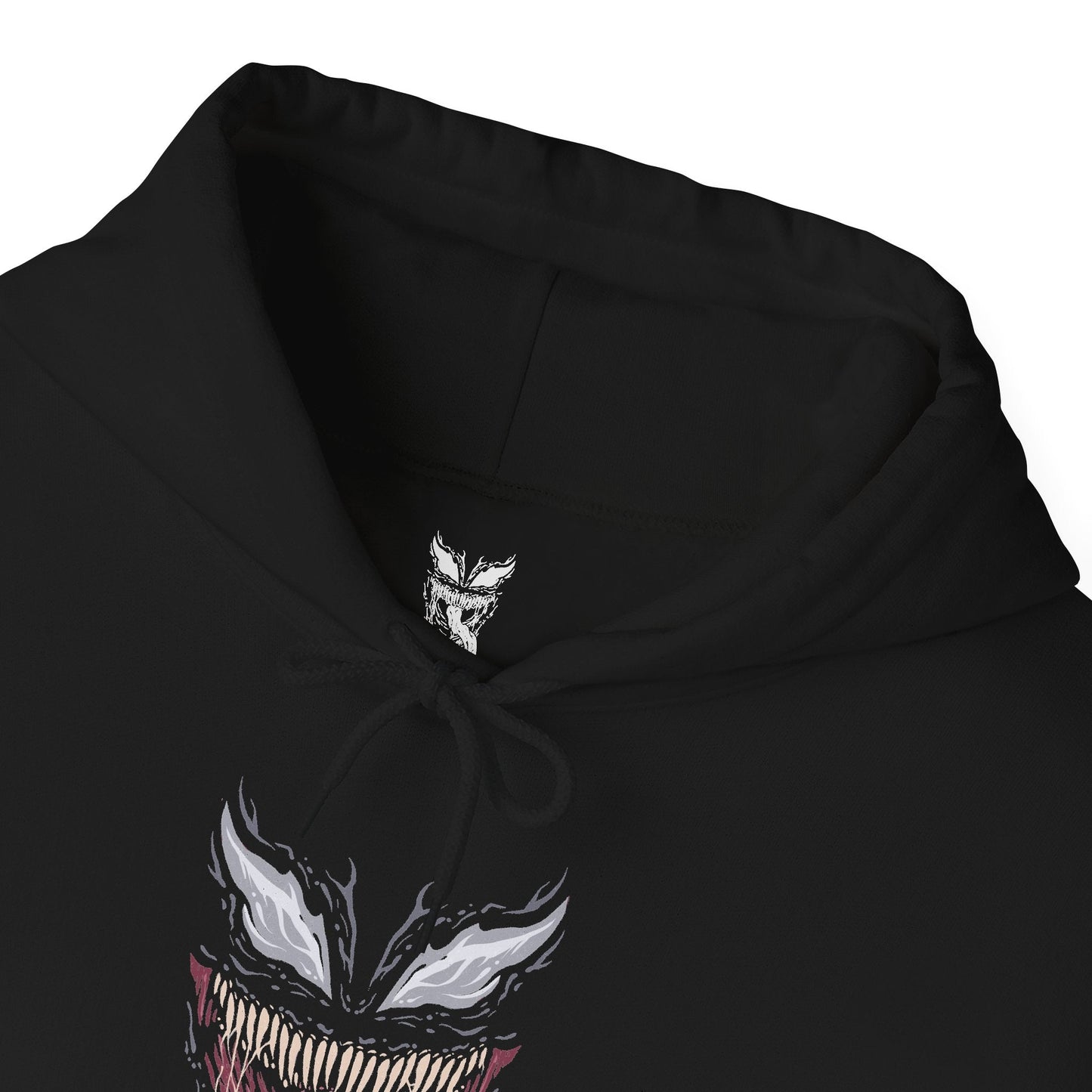 Folded Hooded Sweatshirt of Venom standing atop a gothic city rooftop at night, muscular frame covered in shifting symbiote texture as lightning flashes behind him. His jagged grin and enormous fangs create a terrifying silhouette against the storm. The composition emphasizes brutality, alien corruption, and the overwhelming presence of a creature driven by rage and instinct.