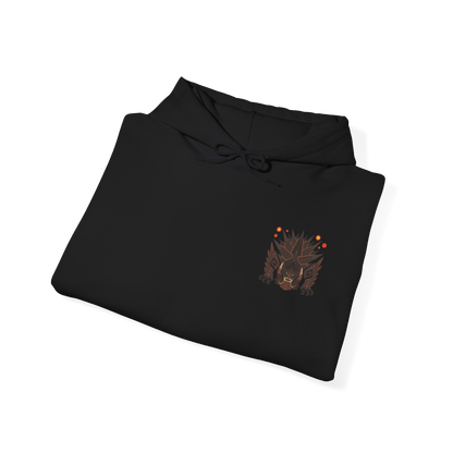 Image 6 of a Hooded Sweatshirt of Akantor charging across a shattered volcanic landscape, its massive jaws open in a devastating roar as fire and debris erupt around its body. Dark smoke fills the horizon while crimson energy glows across its eyes and mouth. The composition emphasizes primal brutality, immense scale, and the unstoppable force of a monster capable of reshaping the battlefield through sheer physical power.