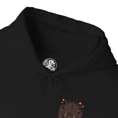 Folded Hooded Sweatshirt of Akantor charging across a shattered volcanic landscape, its massive jaws open in a devastating roar as fire and debris erupt around its body. Dark smoke fills the horizon while crimson energy glows across its eyes and mouth. The composition emphasizes primal brutality, immense scale, and the unstoppable force of a monster capable of reshaping the battlefield through sheer physical power.