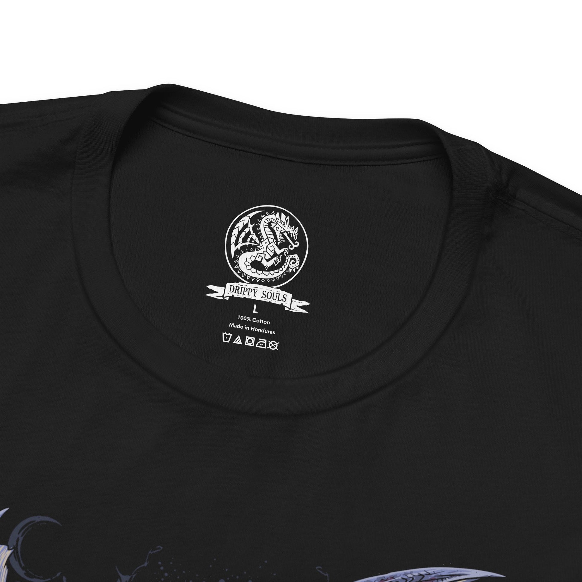 Folded T-Shirt design of Alatreon from Monster Hunter, the Blazing Black Dragon descending through a storm as fire, ice, thunder, dragon, and water elements erupt around its colossal body. Massive black horns and razor-sharp wings dominate the battlefield while the sky fractures beneath its elemental wrath. The design captures Alatreon's mastery over every element, embodying catastrophic power and the fear inspired by one of Monster Hunter's most legendary Black Dragons.