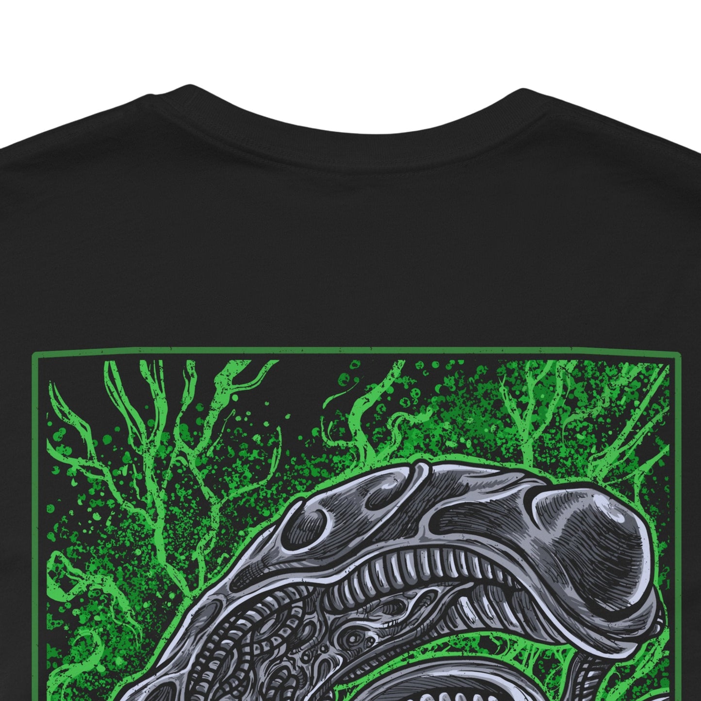 Image 7 of a T-Shirt artwork depicting a Xenomorph stalking through a dark spaceship corridor, steam rising from vents as its skeletal body blends into the environment. Its tail coils behind it while dim red lights flicker across metallic walls. This design reflects survival horror at its peak, emphasizing stealth, fear, and the relentless nature of one of cinema’s most iconic monsters.