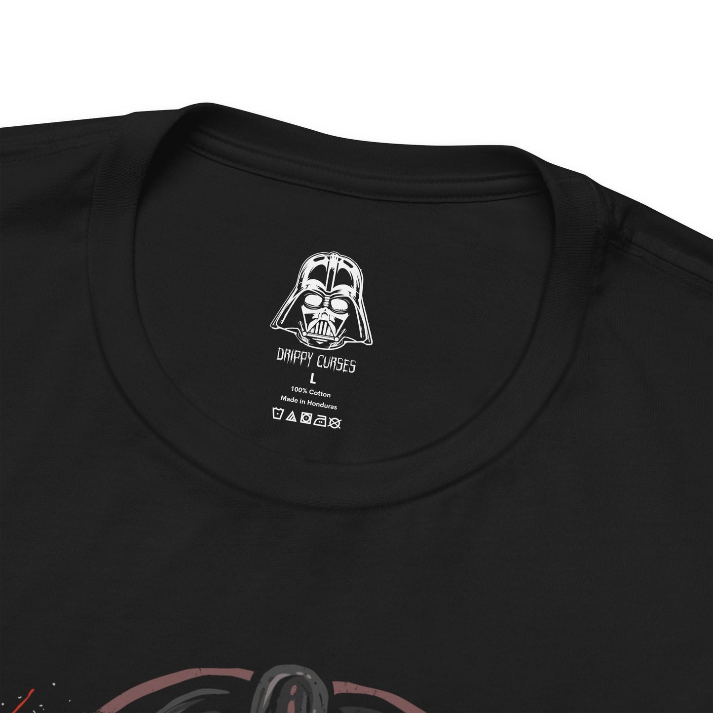 Folded T-Shirt design of Anakin Skywalker and Darth Vader from Star Wars, standing divided by light and shadow as blue and red lightsabers glow against a darkened battlefield. Anakin’s determined gaze contrasts with Vader’s imposing armored form, symbolizing the tragic fall of a hero. The design captures the transformation, inner conflict, and destiny that reshaped the galaxy.