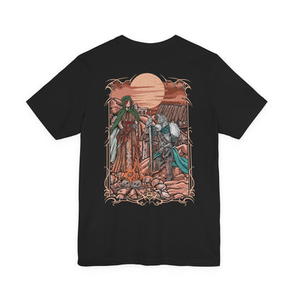 Image 5 of a T-shirt artwork depicting the Faraam-armored Bearer of the Curse facing the horizon while the Emerald Herald stands quietly behind, her presence calm yet solemn. Golden light from the setting sun reflects across broken stone and distant seas. This design reflects the Herald’s role in guiding the undead and the burden carried by the chosen one seeking to break or embrace the curse.