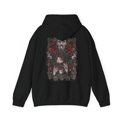 Image 5 of a Hooded Sweatshirt of Billy the Puppet staring forward with a sinister grin, his black suit and red bow tie framed by chains, gears, and rusted metal. A dim industrial setting fades behind him as ominous red light highlights his face. The composition emphasizes psychological tension, horror, and the iconic image of the puppet who announces Jigsaw’s deadly games.