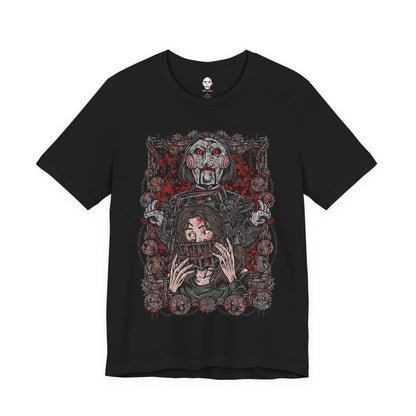 Image 4 of a T-Shirt design of Billy the Puppet from Saw, seated on his tricycle in a dimly lit room surrounded by rusted chains, flickering lights, and blood-stained walls. His pale face, spiraled red cheeks, and unblinking eyes create an unsettling presence. The design captures the psychological horror of Jigsaw’s games and the fear of being forced to choose between survival and sacrifice.