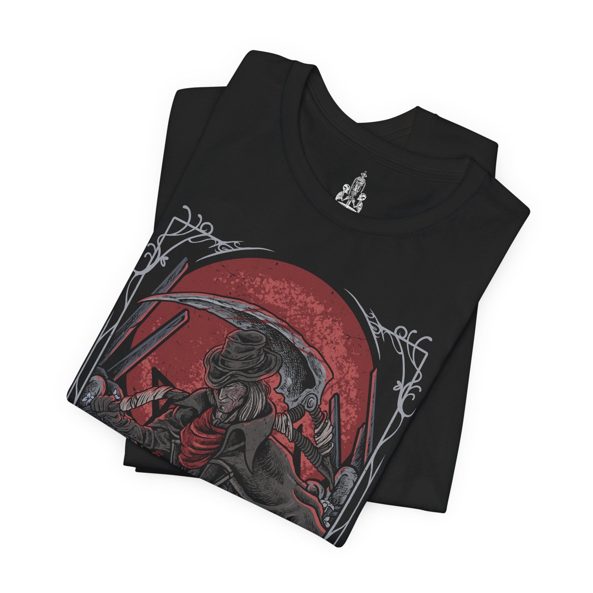 Folded T-shirt design of Gehrman, the First Hunter from Bloodborne, standing within the Hunter’s Dream as pale flowers sway beneath a moonlit sky. His scythe-like Burial Blade gleams with old blood, while the Great Tree and workshop loom behind him. The design captures his tragic role as mentor and prisoner of the Moon Presence, bound eternally to guide hunters through endless nights of slaughter.
