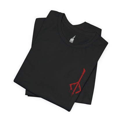 Folded T-shirt featuring the Hunter of Yharnam from Bloodborne, cloaked in worn leathers and wielding iconic trick weapons amid a city drenched in blood and madness. As a lone warrior facing beasts and cosmic horrors, the Hunter stands as a symbol of perseverance in a world ruled by eldritch decay. This design captures the gothic horror at the heart of the Hunt.