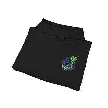 Image 6 of a Hooded Sweatshirt of Brachydios standing amid a crater filled with smoke and burning debris, luminous green slime dripping from its horn and forearms as it prepares another crushing attack. Volcanic ash darkens the sky while explosions illuminate the battlefield. The composition emphasizes destructive power, explosive energy, and the iconic presence of one of Monster Hunter’s most formidable brute wyverns.