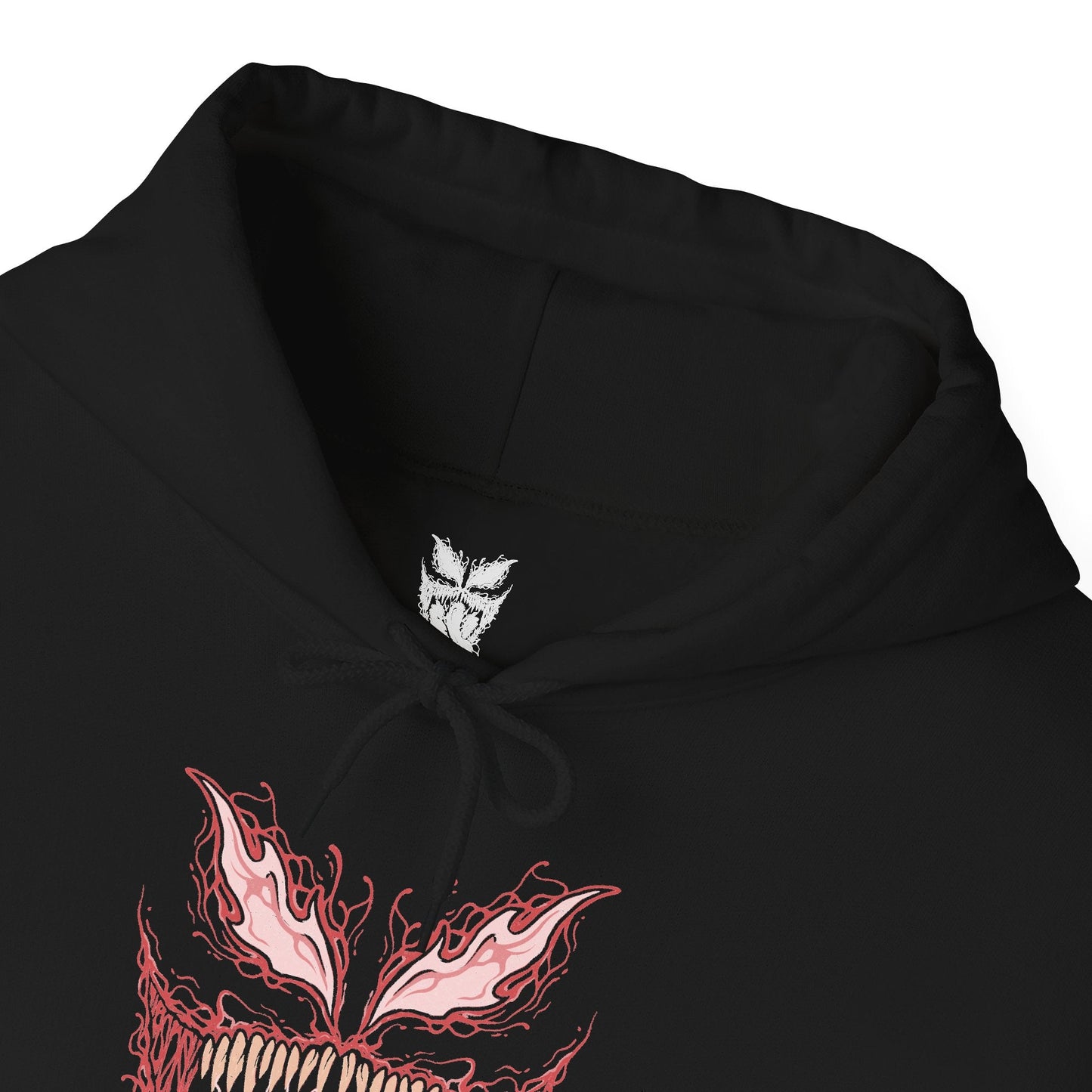 Folded Hooded Sweatshirt of Carnage standing amid destruction as symbiote blades and tendrils spiral outward from his body like living weapons. The crimson creature towers against a dark urban backdrop while debris and shadow surround him. The composition emphasizes horror, chaos, and the overwhelming bloodthirst that defines the Carnage symbiote’s terrifying existence.