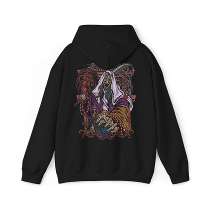 Image 5 of a Hooded Sweatshirt of the Corrupted Monk standing amid crimson mist as the centipede parasite emerges from her body, its segmented form gleaming with unnatural life. Temple ruins loom behind her while ghostly petals drift through the air, emphasizing the clash between holy devotion and monstrous survival. The design conveys horror, decay, and the cursed persistence that defines Ashina’s fallen guardians.