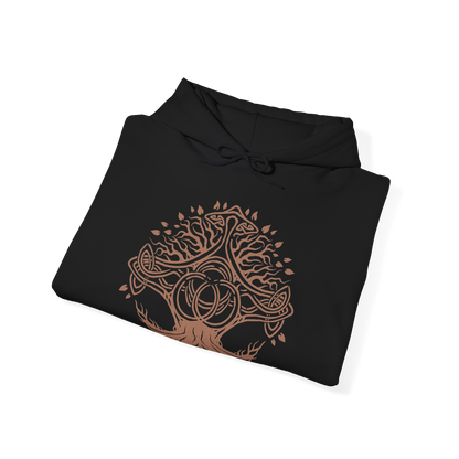 Image 6 of a Hooded Sweatshirt of Crucible Knight Ordovis standing beneath the roots of the ancient Erdtree, his ornate Golden Crucible Tree armor illuminated by radiant golden light. Ordovis grips his massive greatsword as swirling Crucible energy gathers around his armored body and ancient stone surrounds the battlefield. The composition emphasizes his imposing presence, sacred heritage, and connection to the primordial Crucible.