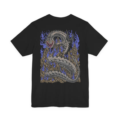 Image 5 of a T-Shirt artwork depicting Dalamadur twisting its enormous serpentine body around a jagged mountain while hunters battle across its scales below. The Elder Dragon's massive head emerges from the darkness with its jaws open, revealing enormous fangs as poisonous energy gathers around its mouth. Storm clouds, cliffs, and scattered hunters emphasize the creature's overwhelming size.