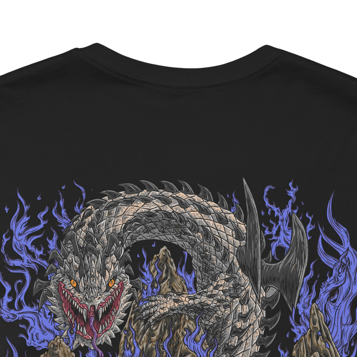 Image 7 of a T-Shirt artwork depicting Dalamadur twisting its enormous serpentine body around a jagged mountain while hunters battle across its scales below. The Elder Dragon's massive head emerges from the darkness with its jaws open, revealing enormous fangs as poisonous energy gathers around its mouth. Storm clouds, cliffs, and scattered hunters emphasize the creature's overwhelming size.