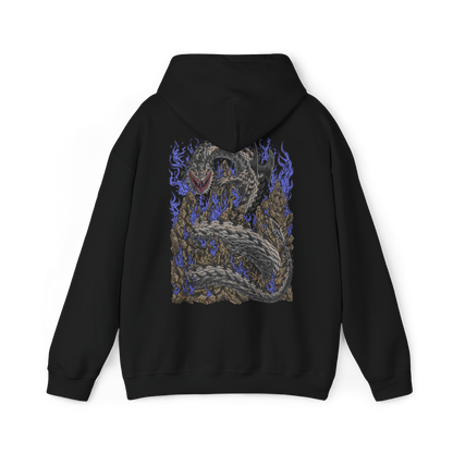 Image 5 of a Hooded Sweatshirt of Dalamadur from Monster Hunter 4 Ultimate, showing the gigantic Elder Dragon coiling around a mountain range as its enormous head rises above the clouds. Dark scales, jagged spines, and huge fangs dominate the composition while poisonous energy glows around its jaws. Lightning, rocky peaks, and tiny hunters below emphasize the staggering scale of the ancient serpent.