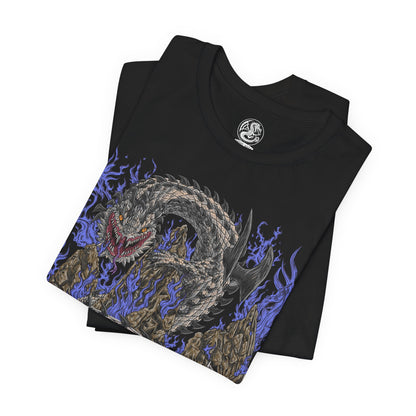 Image 5 of a T-Shirt design of Dalamadur from Monster Hunter 4 Ultimate, depicting the colossal black serpentine Elder Dragon coiling around towering mountain peaks beneath a storm-filled sky. Its enormous fanged head rises above the landscape while its long body winds through the rocky battlefield. The artwork emphasizes Dalamadur's immense scale, ancient power, and terrifying presence.