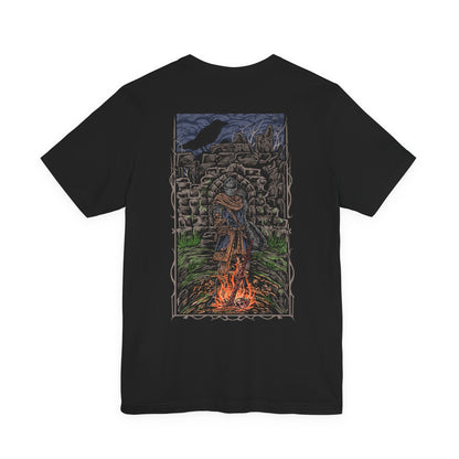 Image 5 of a T-shirt showcasing the Chosen Undead within Firelink Shrine, the central resting place of Dark Souls. Amid the ruined stonework and eternal bonfire, the hero prepares for battles against gods, dragons, and abyssal horrors. This artwork reflects the atmosphere of despair and resolve that defines the Undead’s fated quest.