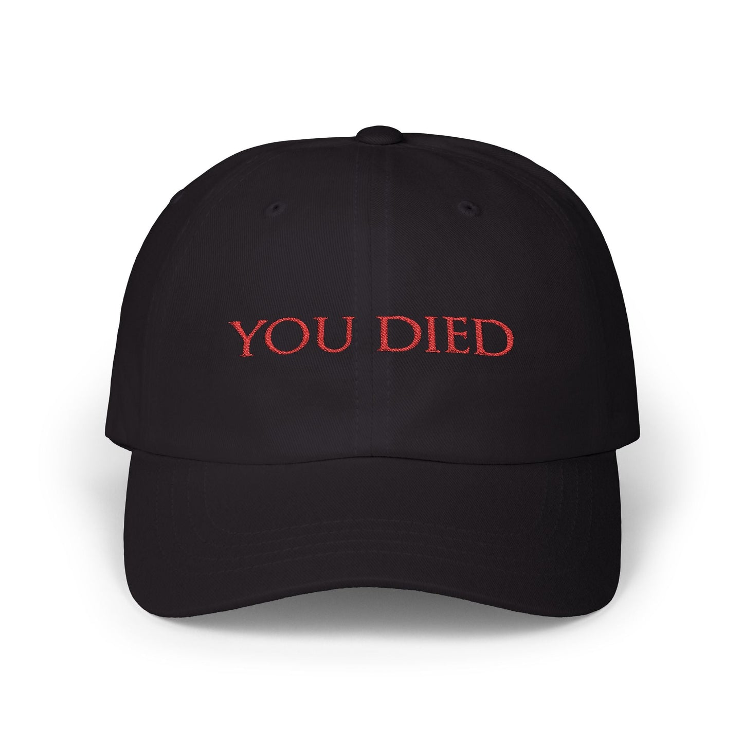 Image 3 of a Black Embroidered Cap featuring the iconic “You Died” screen from Dark Souls, a legendary meme recognized by gamers worldwide. Displayed in bold red text over a black backdrop, this phrase symbolizes brutal difficulty, hard-earned lessons, and countless player deaths. A perfect design for fans who wear their defeats with pride and humor.