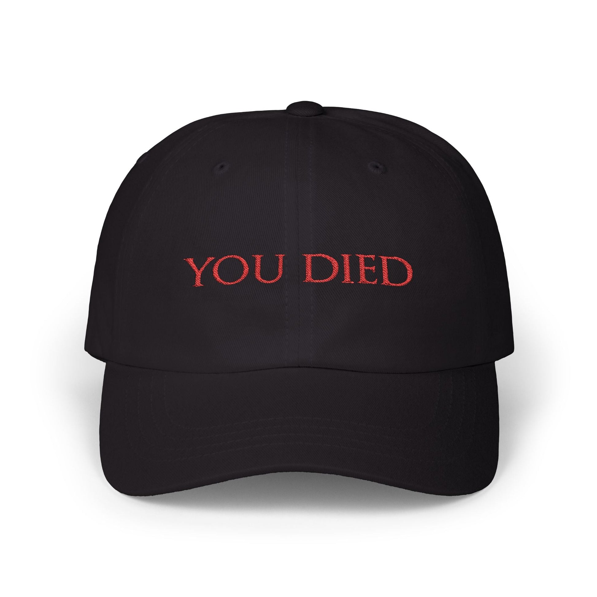Image 3 of a Black Embroidered Cap featuring the iconic “You Died” screen from Dark Souls, a legendary meme recognized by gamers worldwide. Displayed in bold red text over a black backdrop, this phrase symbolizes brutal difficulty, hard-earned lessons, and countless player deaths. A perfect design for fans who wear their defeats with pride and humor.