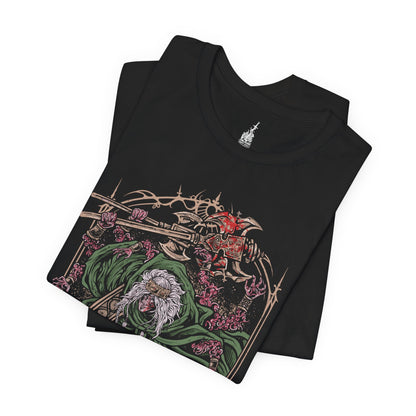 Folded T-shirt featuring Godrick the Grafted from Elden Ring, the grotesque demigod of Stormveil Castle. Known for grafting countless limbs onto his body to fuel his strength, Godrick embodies ambition twisted into monstrosity. This design captures his terrifying form, symbolizing his hunger for power and his legacy as one of the first shardbearers.