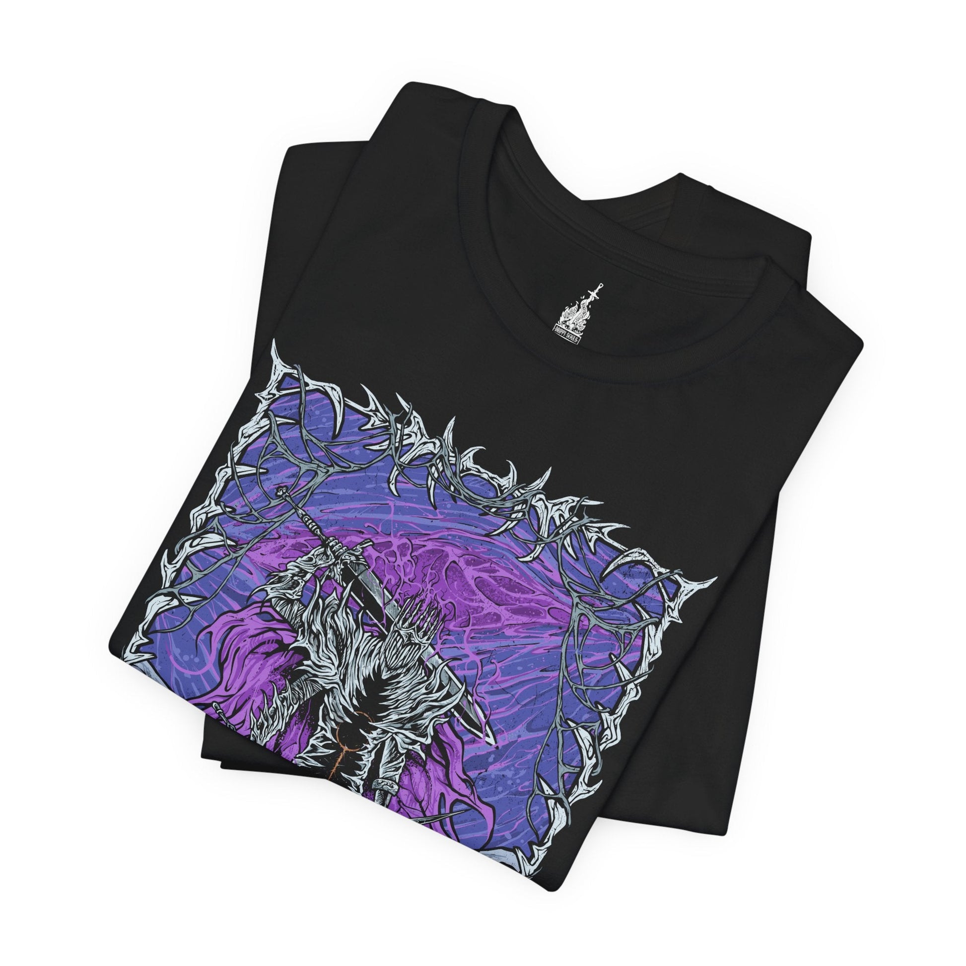 Folded T-shirt featuring Heolstor the Nightlord from Elden Ring Nightreign, a once-fallen knight who rose from a mountain of corpses to curse the world. Ruling the Lands Between after the Shattering, Heolstor commands monsters and champions from other realms, embodying the terror of the Night’s Tide. This design captures the grim majesty of his eternal rule.