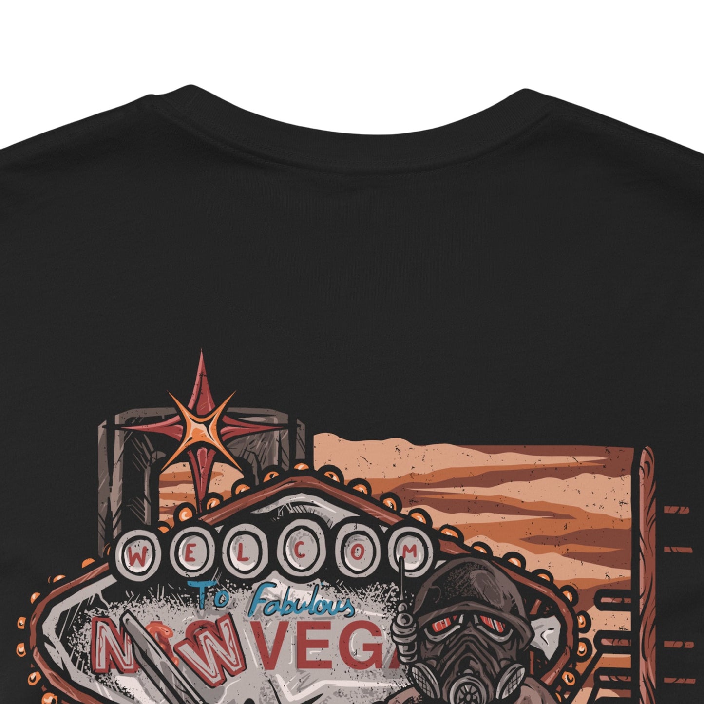 Image 7 of a T-Shirt artwork depicting an NCR Veteran Ranger overlooking the Mojave Wasteland from a rocky overlook, with the New Vegas Strip glowing in the distance. Dust storms sweep across abandoned highways while the ranger's signature helmet reflects the fading sunlight. This design reflects justice, survival, and the harsh realities of protecting civilization on the edge of a nuclear wasteland.