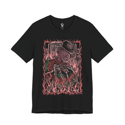 Image 4 of a T-Shirt design of Freddy Krueger from A Nightmare on Elm Street, emerging from a nightmare-filled darkness with his bladed glove extended toward the viewer. His burned face twists into a sinister grin beneath a worn fedora while red and green stripes fade into shadow behind him. The design captures dreamlike terror, psychological horror, and the unstoppable fear haunting Elm Street.