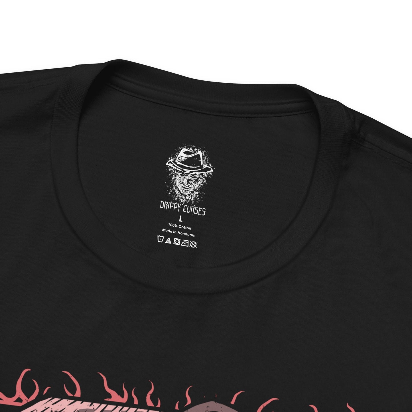 Folded T-Shirt design of Freddy Krueger from A Nightmare on Elm Street, emerging from a nightmare-filled darkness with his bladed glove extended toward the viewer. His burned face twists into a sinister grin beneath a worn fedora while red and green stripes fade into shadow behind him. The design captures dreamlike terror, psychological horror, and the unstoppable fear haunting Elm Street.
