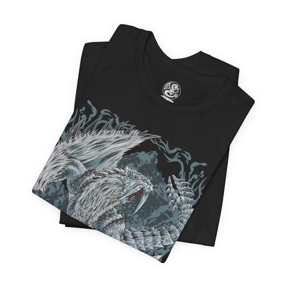 Image 5 of a T-Shirt design of Frostfang Barioth from Monster Hunter World: Iceborne, showcasing the enormous fanged wyvern with its distinctive frost-covered tusks, armored scales, and powerful wings spread wide. Icy mist and frozen particles surround the beast as it prepares to unleash a devastating freezing breath attack. The artwork captures its predatory aggression, wintry appearance, and terrifying presence as one of the most dangerous monsters lurking in the frozen Hoarfrost Reach.