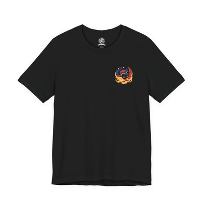 Image 4 of a T-Shirt artwork depicting Glavenus dragging its colossal blade tail across rocky terrain, igniting the earth as blazing embers and smoke trail behind each movement. Its armored crimson scales shimmer beneath the heat while towering cliffs frame the battlefield. This design reflects Glavenus' mastery of fiery melee combat, combining brute force, calculated strikes, and relentless aggression against any hunter that dares challenge it.