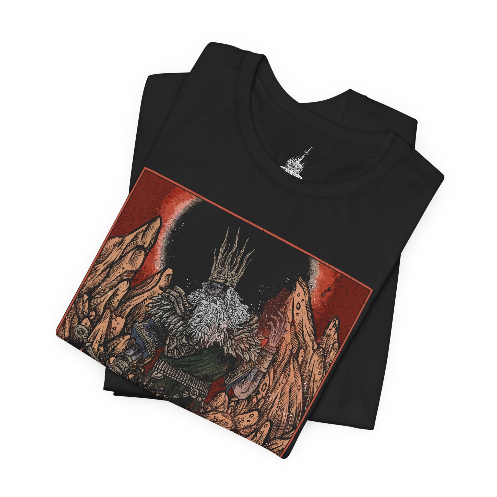 Image 5 of a T-shirt featuring Gwyn, Lord of Cinder from Dark Souls, the once-mighty god who sacrificed his soul to link the First Flame. Clad in tattered robes and wielding a flaming greatsword, Gwyn is a tragic figure—his power diminished, his body consumed by fire. This design captures his solemn stance within the Kiln of the First Flame, symbolizing the fading age of gods and the cost of clinging to light in a world on the brink of darkness.