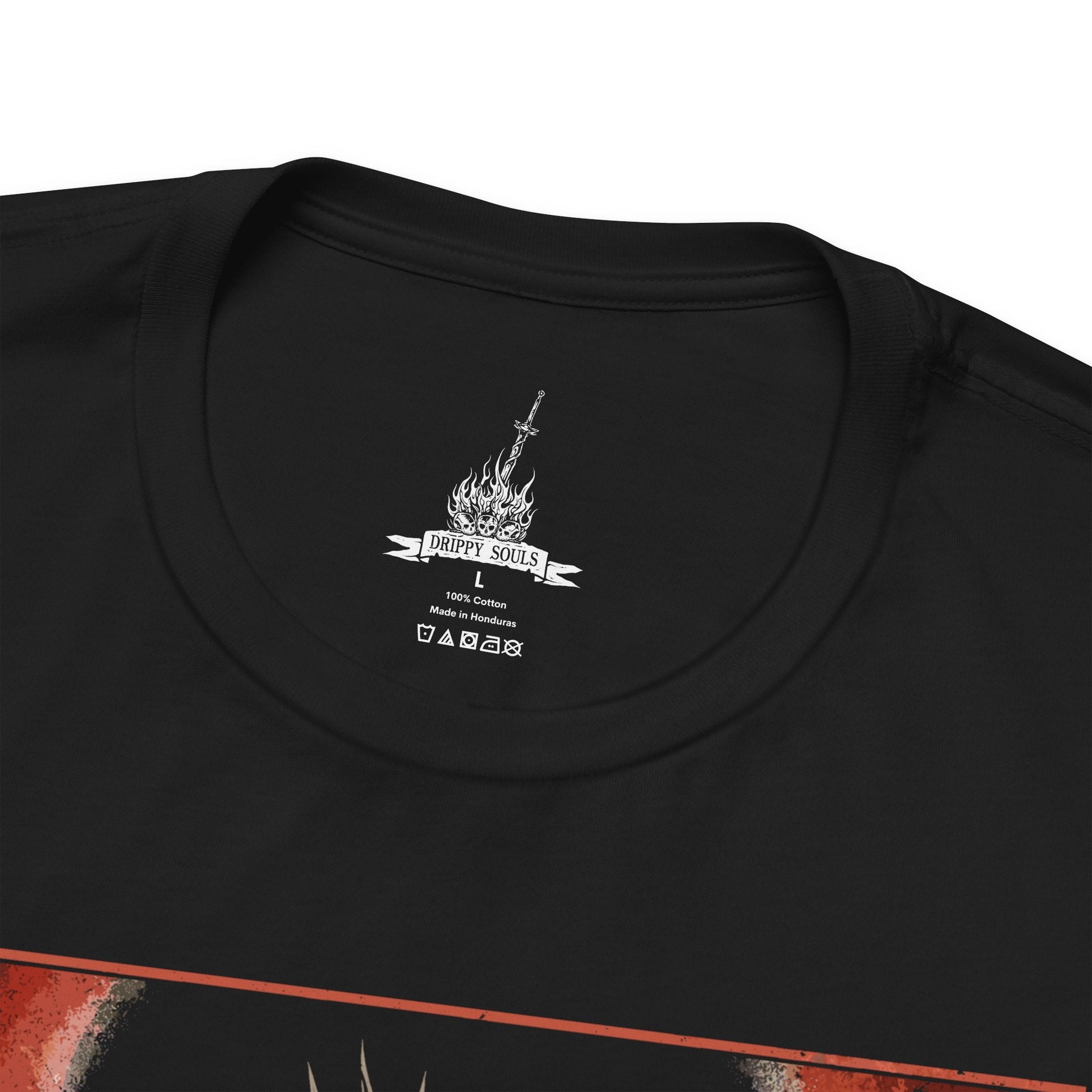 Folded T-shirt featuring Gwyn, Lord of Cinder from Dark Souls, the once-mighty god who sacrificed his soul to link the First Flame. Clad in tattered robes and wielding a flaming greatsword, Gwyn is a tragic figure—his power diminished, his body consumed by fire. This design captures his solemn stance within the Kiln of the First Flame, symbolizing the fading age of gods and the cost of clinging to light in a world on the brink of darkness.