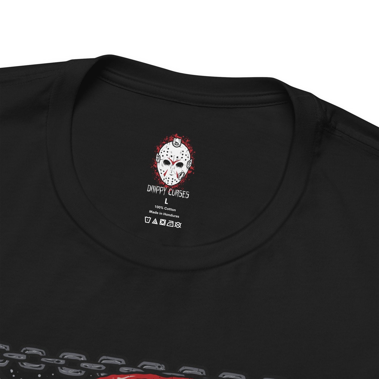 Folded T-Shirt design of Jason Voorhees from Friday the 13th, standing at the edge of Crystal Lake beneath a moonlit sky. His hockey mask reflects dim light as he grips a bloodstained machete, with trees and cabins fading into darkness behind him. The design captures the eerie silence of the camp and the unstoppable presence of a killer bound to the легенd of Crystal Lake.