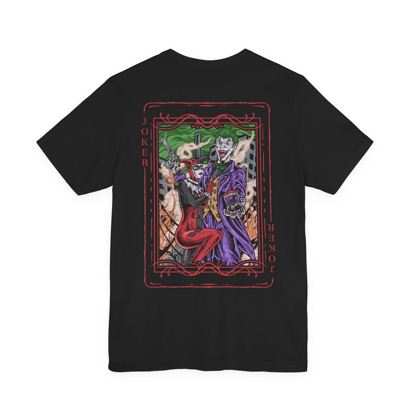 Image 5 of a T-Shirt artwork depicting the Joker and Harley Quinn embracing chaos in the streets of Gotham City, with explosions, scattered poker chips, and purple-green smoke filling the background. The Joker flourishes a deck of cards while Harley balances her signature bat across her shoulders. This design reflects madness, rebellion, and the twisted bond that blurs the line between obsession, loyalty, and destruction.