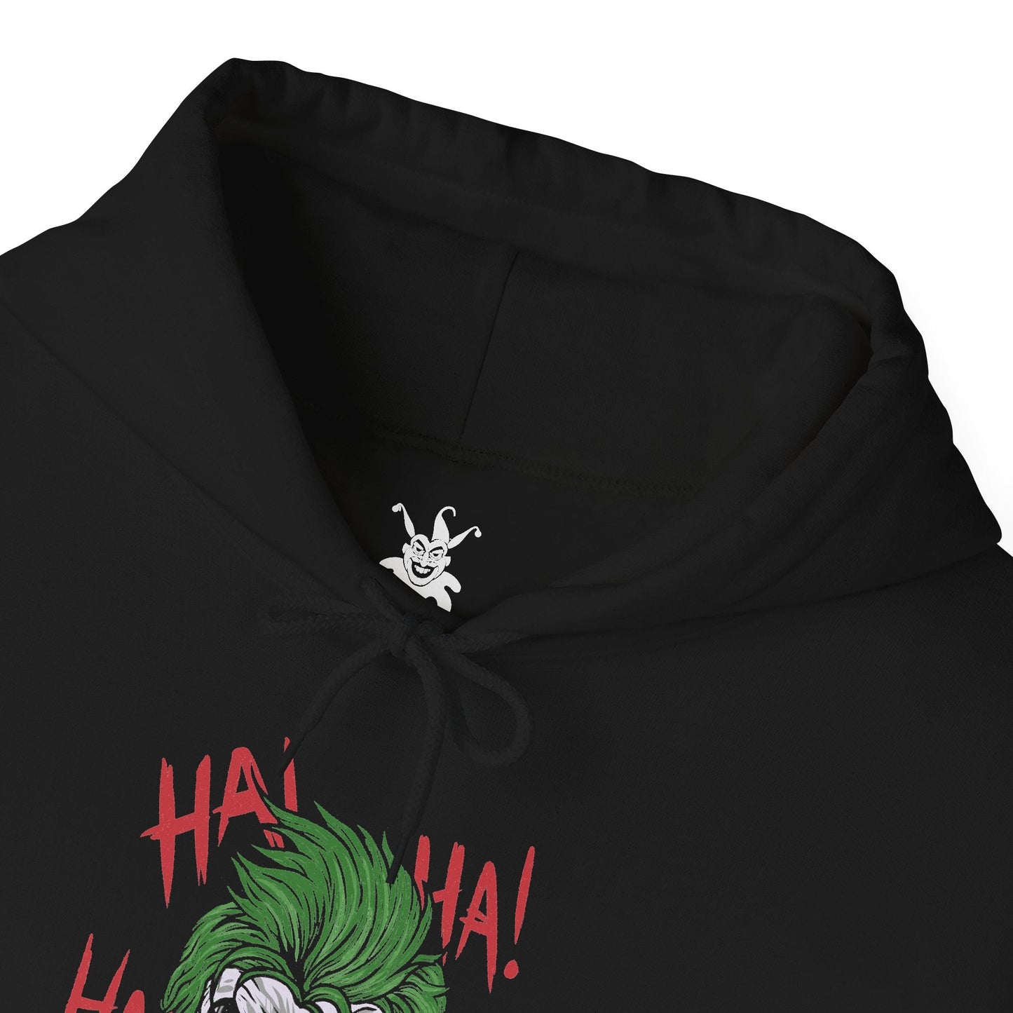 Folded Hooded Sweatshirt of the Joker and Harley Quinn seated atop a pile of stolen cash and broken carnival props beneath neon lights. Harley’s colorful outfit contrasts with the Joker’s eerie purple suit as confetti and smoke swirl through the air. The composition emphasizes comic-book chaos, psychological manipulation, and the unforgettable partnership between Gotham’s Clown Prince of Crime and his equally unpredictable accomplice.