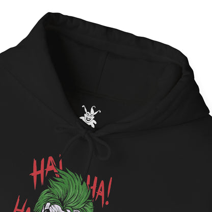 Folded Hooded Sweatshirt of the Joker and Harley Quinn seated atop a pile of stolen cash and broken carnival props beneath neon lights. Harley’s colorful outfit contrasts with the Joker’s eerie purple suit as confetti and smoke swirl through the air. The composition emphasizes comic-book chaos, psychological manipulation, and the unforgettable partnership between Gotham’s Clown Prince of Crime and his equally unpredictable accomplice.
