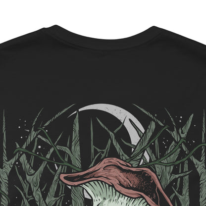 Image 7 of a T-Shirt artwork depicting the Mushroom People wandering through the forgotten depths of Darkroot Garden, surrounded by moss-covered ruins, towering trees, and drifting fog. Their distinctive fungal forms contrast with the dark woodland environment, creating an eerie yet whimsical scene. This design reflects the mysterious creatures hidden within one of Lordran's most atmospheric forests.