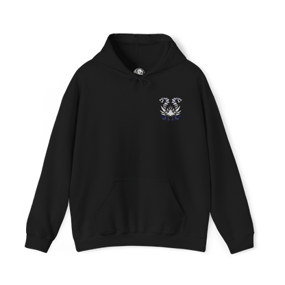 Image 4 of a Hooded Sweatshirt of Nakarkos from Monster Hunter Generations, towering within a vast underground cavern filled with enormous bones and shattered monster skulls. The skeletal Elder Dragon extends its tentacles around the battlefield while eerie energy illuminates its grotesque body. Dark stone, scattered remains, and dramatic shadows emphasize the creature's mysterious and terrifying presence.