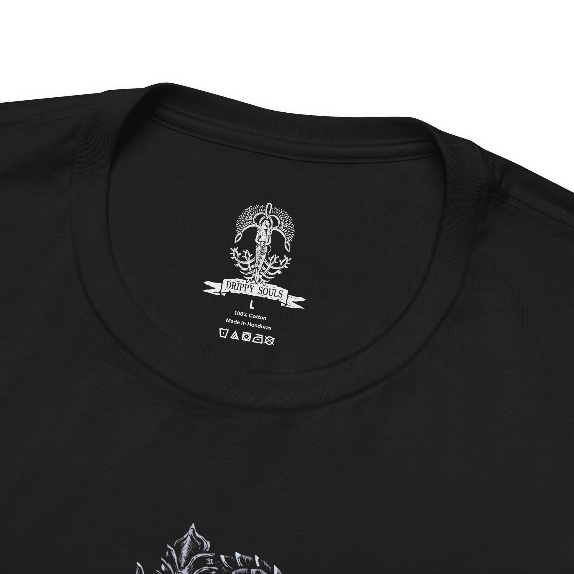 Folded T-shirt featuring Rykard, Lord of Blasphemy from Elden Ring, the demigod who fused with the God-Devouring Serpent in defiance of the Erdtree. Twisted in form and mind, Rykard sacrificed his humanity for power, becoming a grotesque fusion of flesh, flame, and fangs. This design captures his monstrous visage coiled in molten ruin, symbolizing his rebellion against the divine and his descent into unspeakable heresy.