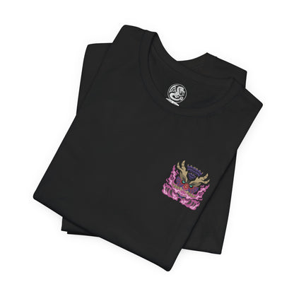 Image 6 of a T-Shirt artwork depicting Scorned Magnamalo unleashing explosive Hellfire across a ruined landscape, its muscular frame covered in battle scars as crimson flames and violet energy spiral around its claws. The ground fractures beneath every step while burning embers fill the air. This design reflects the monster's overwhelming aggression, relentless resilience, and the terrifying power gained through surviving countless brutal battles.