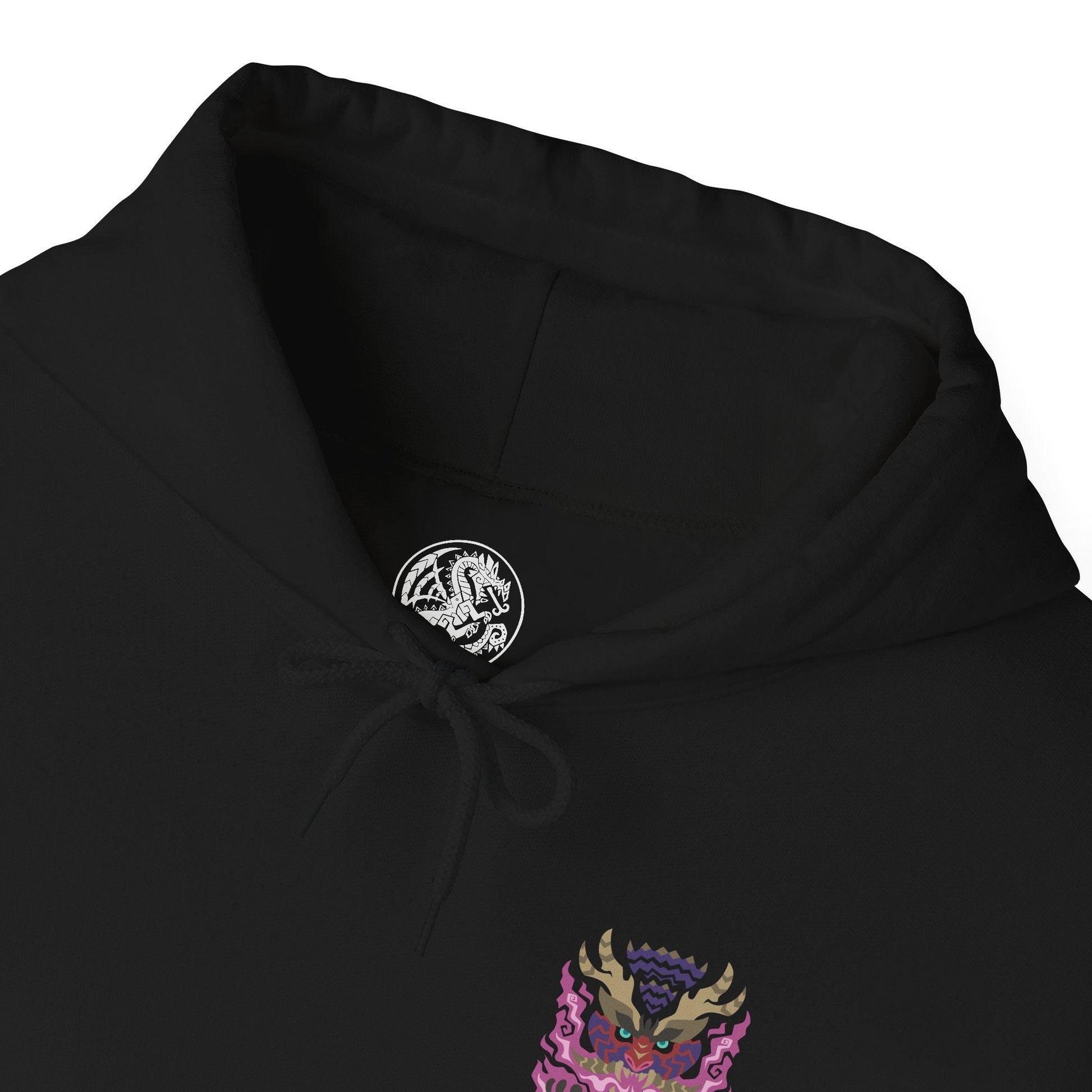 Folded Hooded Sweatshirt of Scorned Magnamalo roaring beneath a storm-dark sky, crimson Hellfire pouring from its armored body as jagged spikes and its massive bladed tail dominate the battlefield. Smoke, ash, and burning debris surround the fearsome predator while its glowing eyes lock onto unseen prey. The composition emphasizes raw power, savage determination, and the legendary presence of one of Monster Hunter's most fearsome flagship monsters.