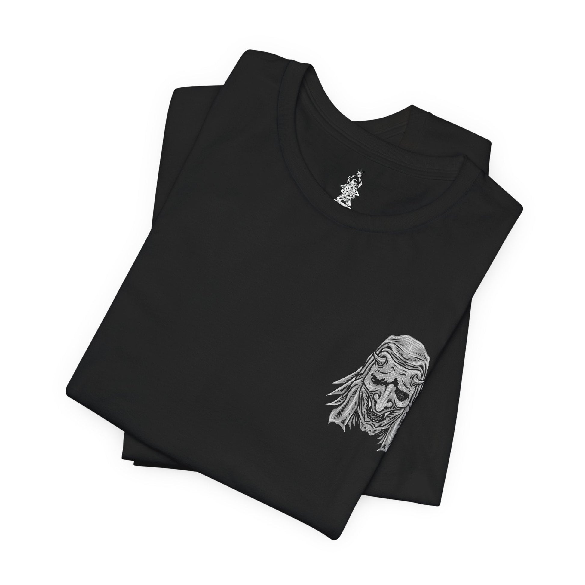 Folded T-shirt artwork depicting the Corrupted Monk’s spectral form torn open to reveal the centipede controlling her corpse. Rotting armor, broken prayer beads, and drifting incense surround the scene as the parasite coils through bone and sinew. This design reflects the blasphemous pursuit of immortality, the corruption of sacred vows, and the nightmarish consequences of defying death in Sekiro’s mythos.