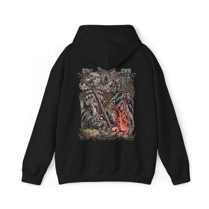 Image 5 of a Hooded Sweatshirt of Siegward of Catarina standing inside Yhorm the Giant's ruined chamber, his rounded Catarina armor reflecting the glow of burning embers as he prepares for his final battle. Smoke and ancient stone surround the knight while the towering silhouette of Yhorm appears behind him. The composition emphasizes friendship, honor, courage, and Siegward's unwavering promise.