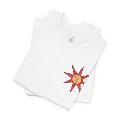 Image 6 of a T-shirt showcasing Solaire of Astora, the sun-praising warrior from Dark Souls who aids the Chosen Undead in battle. Donning his distinct sun-emblazoned tabard and helm, Solaire is a beacon of camaraderie in Lordran’s bleak landscape. This artwork celebrates his unwavering spirit and legendary status among fans.