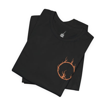 Folded T-shirt artwork depicting the Soul of Cinder wreathed in flame at the heart of the First Flame’s remains, cracked armor glowing with molten fissures. As it transitions into Gwyn’s fiery combat style, lightning and fire erupt around the ashen battlefield. This design reflects legacy, sacrifice, and the cyclical nature of linking the flame that defines the Dark Souls saga.
