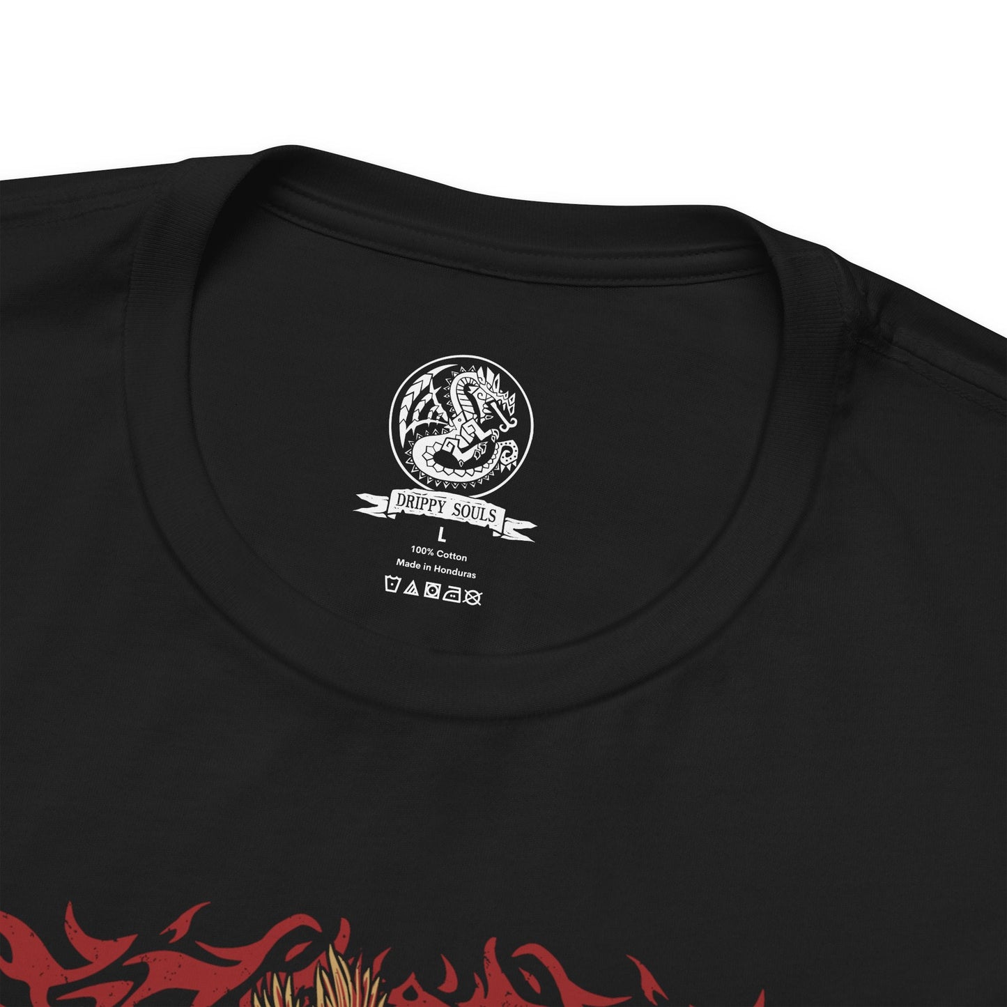 Folded T-Shirt design of Teostra from Monster Hunter, the blazing Elder Dragon standing atop a volcanic ridge as flames and embers erupt around its lion-like body. Its fiery mane glows beneath a smoke-filled sky while explosive dust scatters through the air. The design captures Teostra’s regal presence, destructive fire power, and status as one of the most feared rulers of volcanic regions.