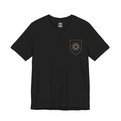 Image 4 of a T-shirt artwork depicting the Beast of White Orchard perched atop ruined battlements, its scarred griffin form roaring against a storm-dark sky. Nilfgaardian armor and fallen soldiers lie scattered below, symbolizing the cost of conquest and neglect. This design captures the beast as both predator and consequence, born from war, neglect, and the crumbling balance between monsters and men.
