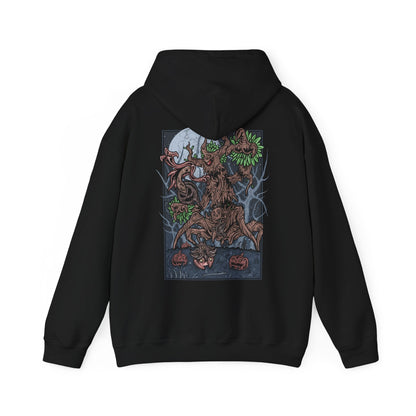 Image 5 of a Hooded Sweatshirt depicting Trevenant looming over a misty woodland path, its silhouette blending with towering trees as glowing eyes watch from the darkness. Subtle faces seem to form within its bark, hinting at the spirits bound inside. The design reflects Trevenant’s lore as a cursed forest spirit Pokémon, symbolizing vengeance, possession, and the eerie life hidden within Kalos forests.